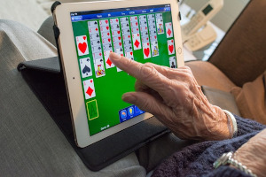 Starsza osoba używająca tabletu